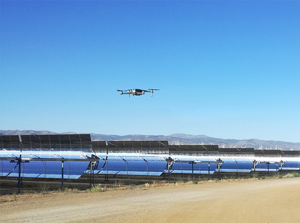 Drone inspecting parabolic trough mirrors at a concentrated solar power (CSP) plant